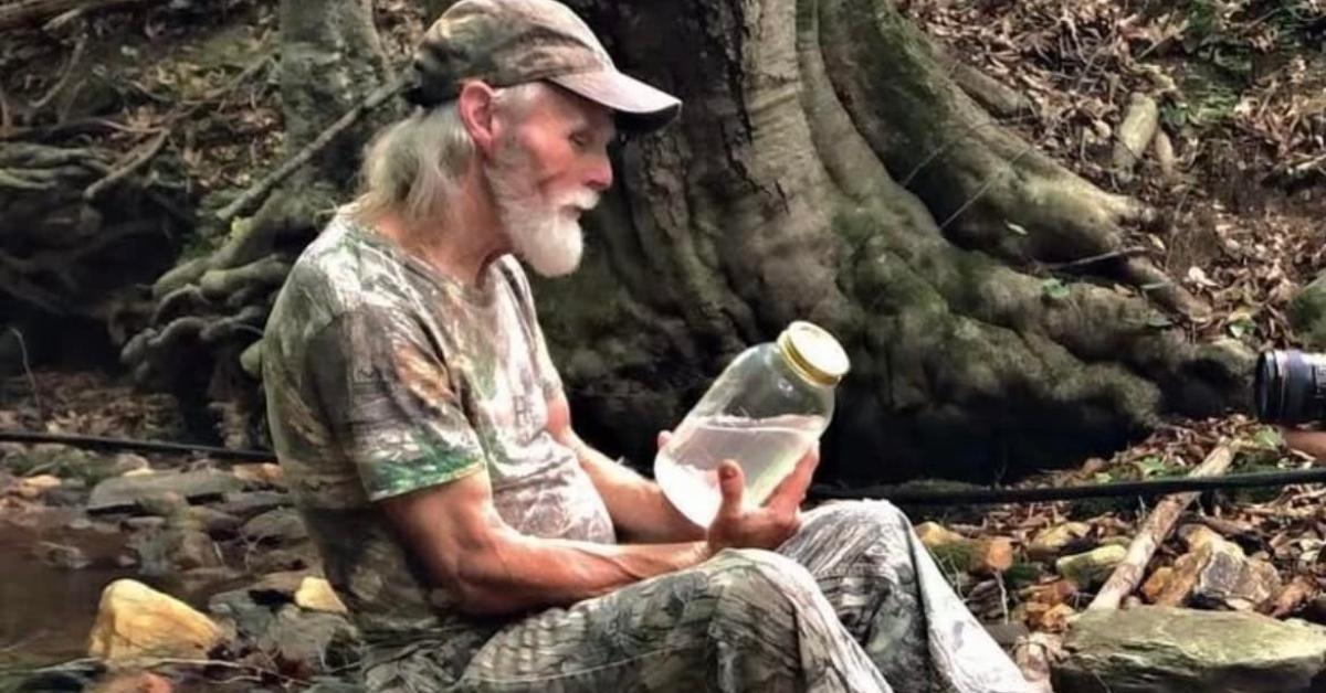 Kenny Law with a jar of moonshine