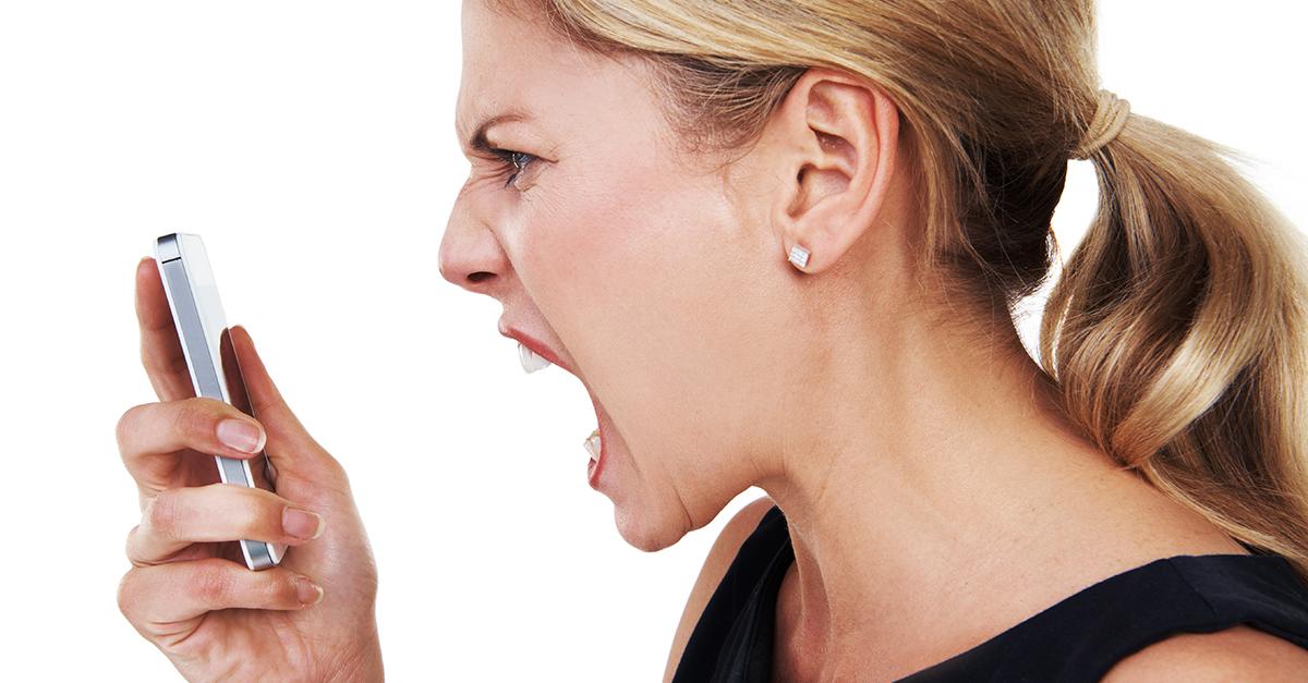 Angry woman holding smartphone