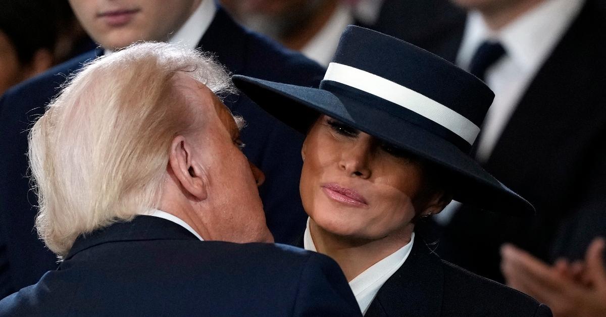 Melania Trump, and her hat, air kiss Donald Trump during his second inauguration