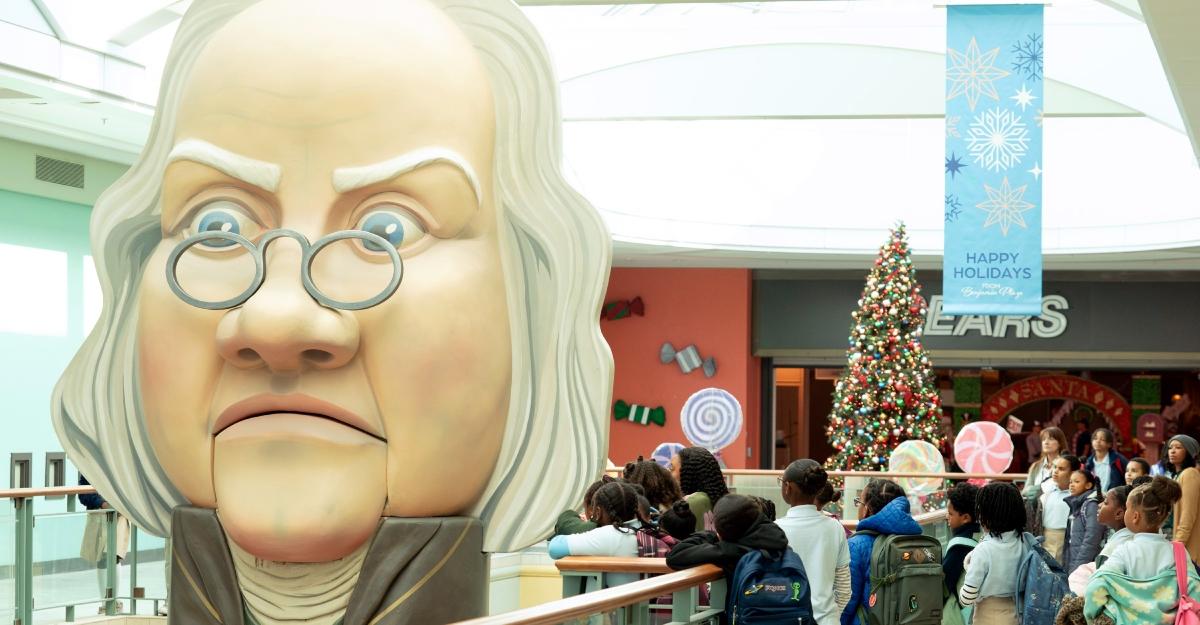 A giant Benjamin Franklin head hovers next to students in the mall in Abbott Elementary.