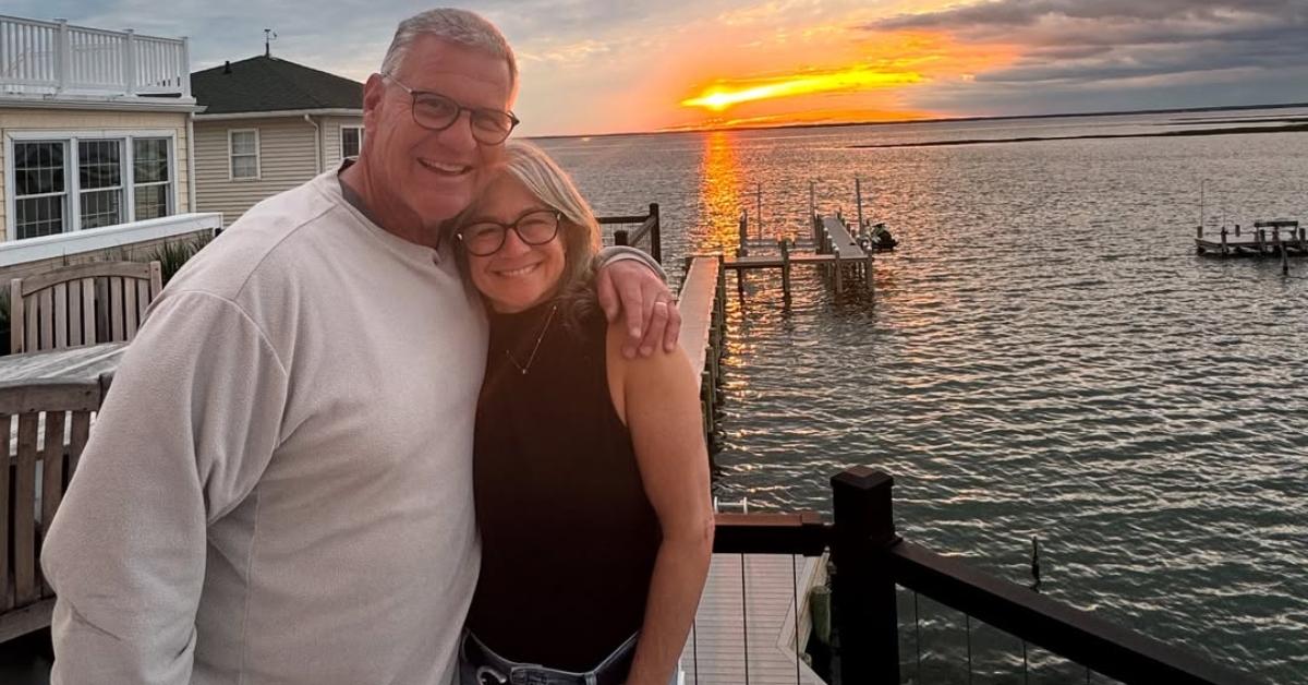 Jeff Stoutland with his wife on a pier.