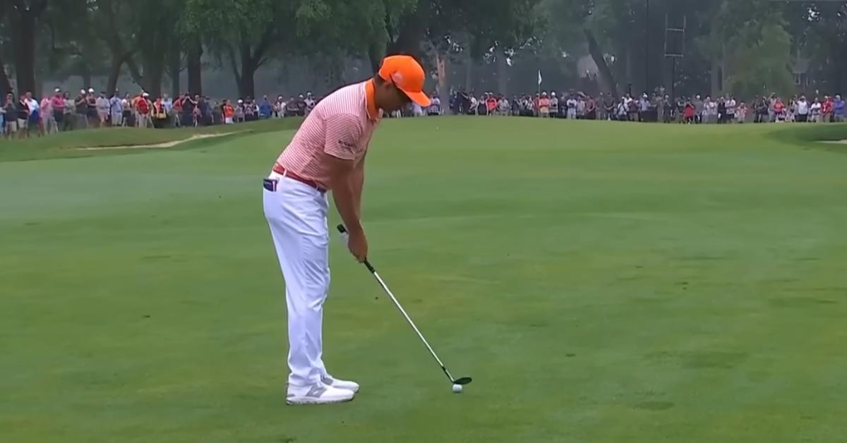 Pro golfer Rickie Fowler preparing to swing.