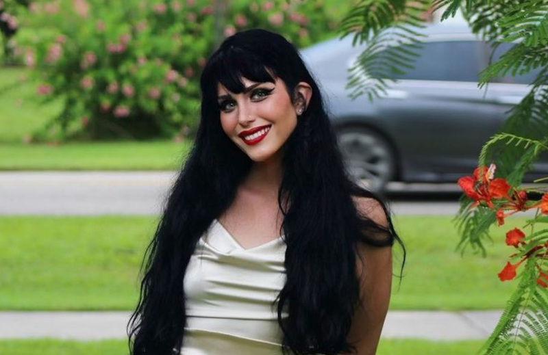 Brittani wearing a cream colored dress outside