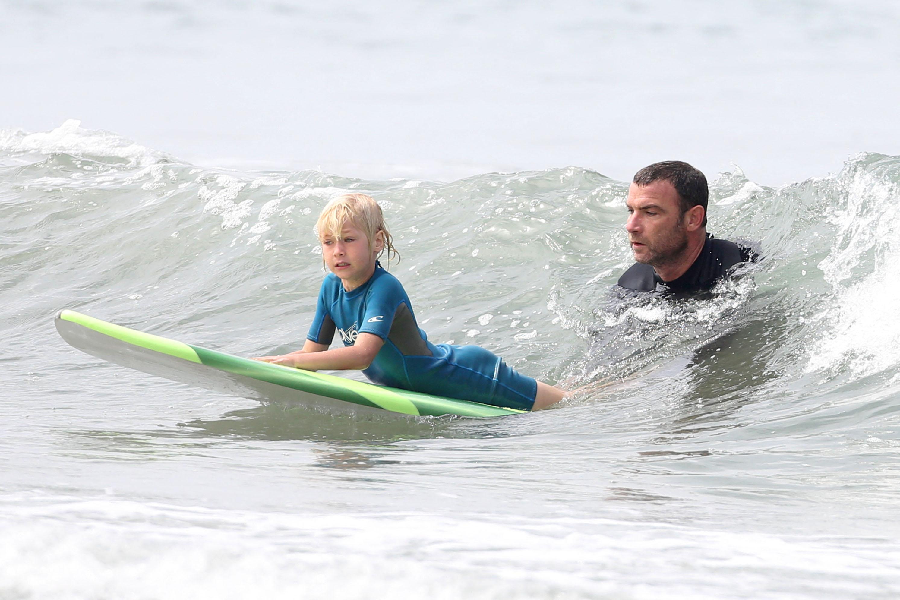 Liev Schreiber teachers his son how to surf.