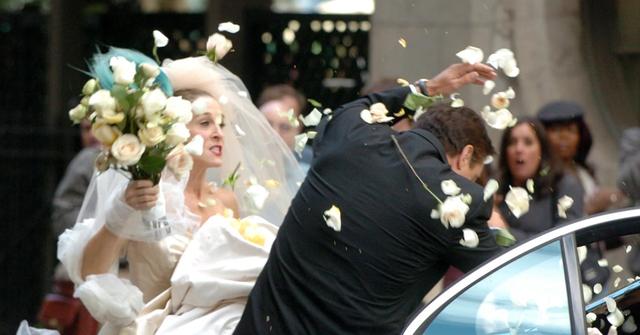Carrie hitting Big with her bouquet on their wedding day