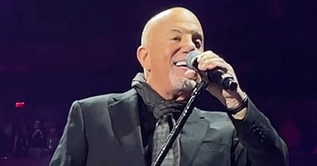 Billy Joel singing into a microphone