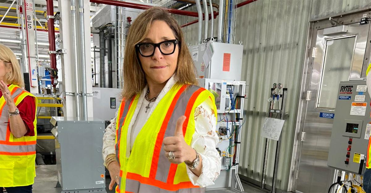 Linda Yaccarino in a safety vest in a factory.