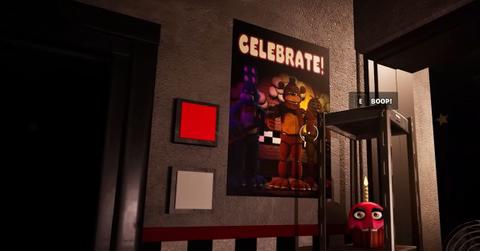 A player looking at a poster in the FNAF Fortnite Creative map.