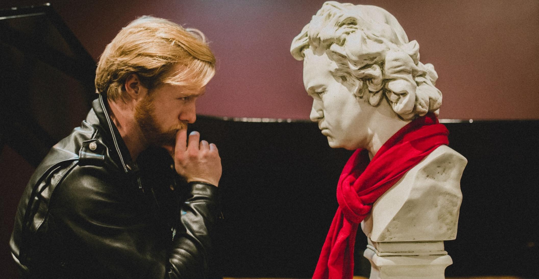 Zachary Hughes stares at a bust of Beethoven