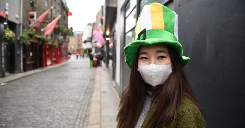 A person in a green and orange hat.
