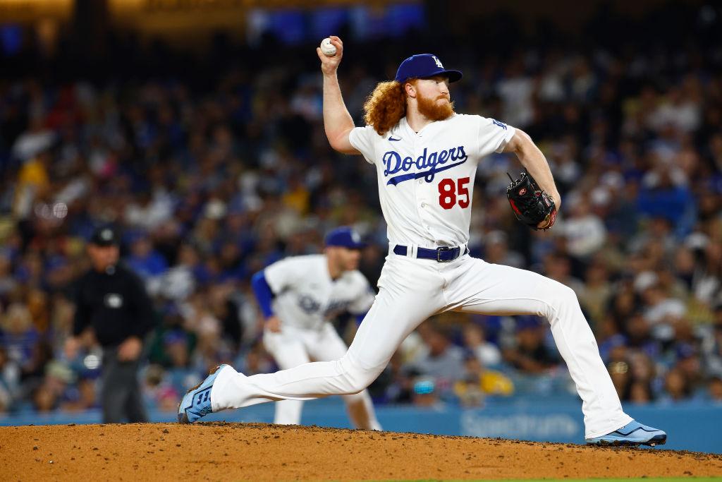 Dodgers pitcher Dustin May leaves after taking line drive off the face