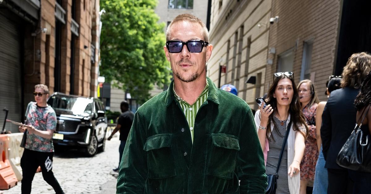 diplo green jacket and green striped shirt