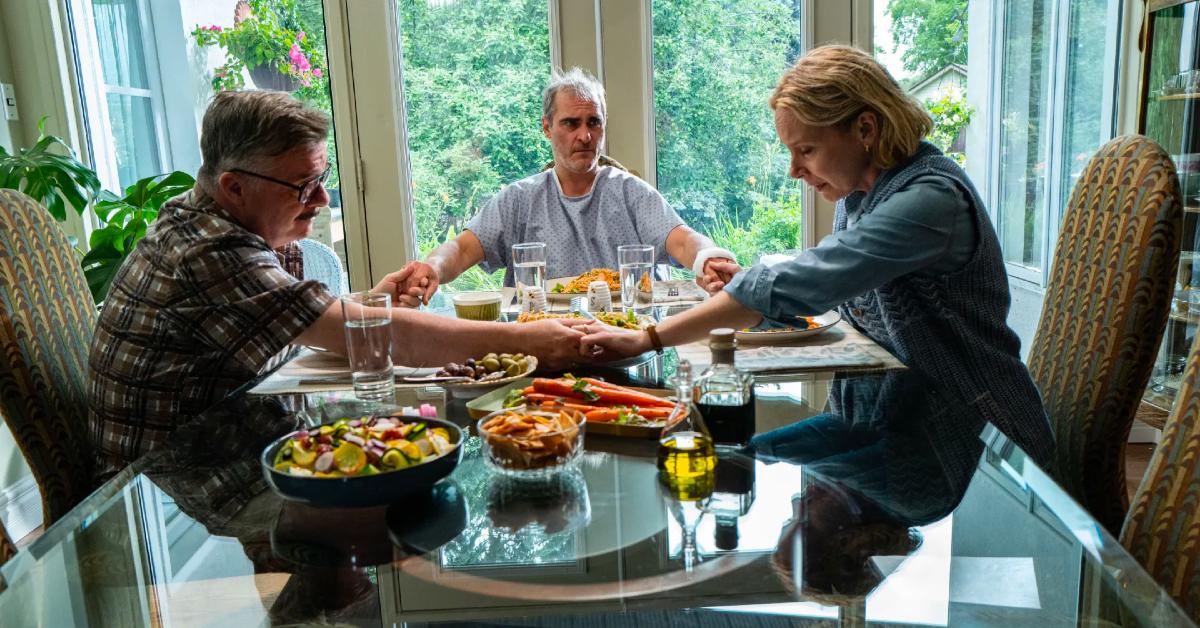 (L-R) Nathan Lane as Roger, Joaquin Phoenix as Beau, and Amy Ryan as Grace in 'Beau Is Afraid.'