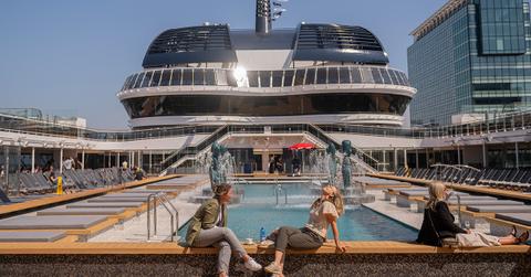 People sitting by a pool on a cruise ship