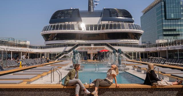 People sitting by a pool on a cruise ship