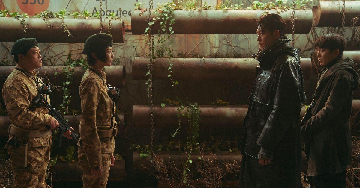 Four officers facing each other in military uniforms.