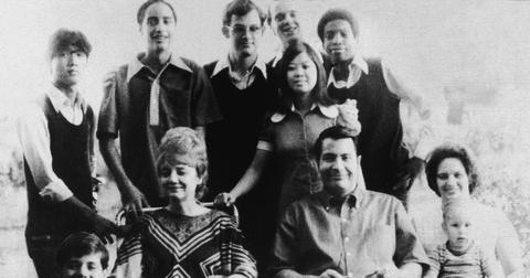 Jim Jones sits next to his wife Marceline (L) along with their adopted children and his sister-in-law (R)