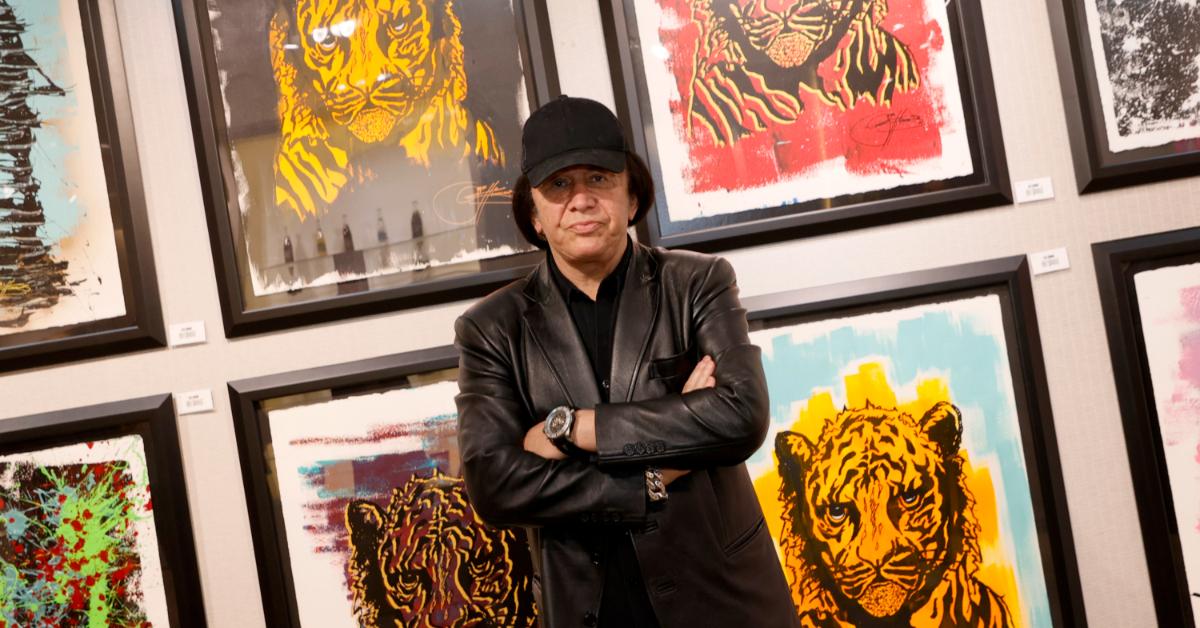 Gene Simmons posing in front of art