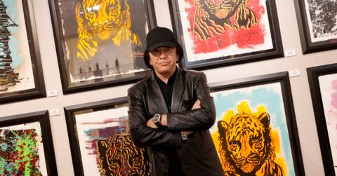 Gene Simmons posing in front of art