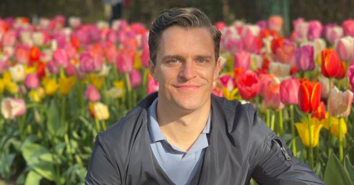 Kevin Sobieski in front of a flower bed.