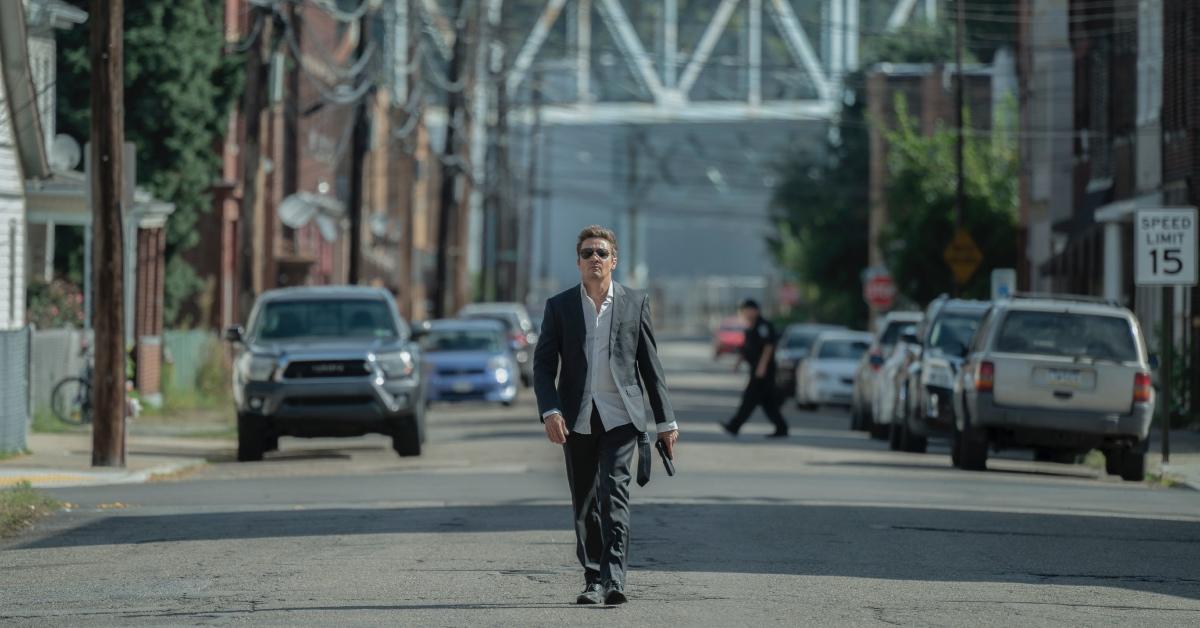 Jeremy Renner walking in the street in 'Mayor of Kingstown'.