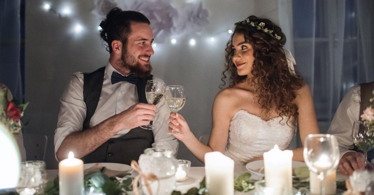 (l-r) A groom and bride toasting on their wedding day.