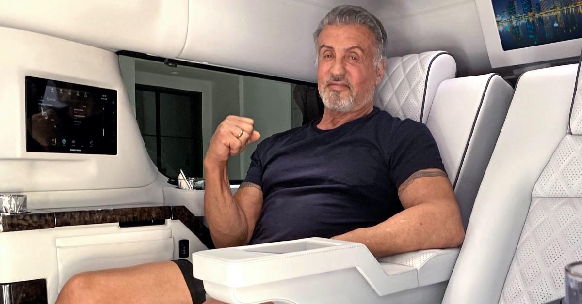 Sylvester Stallone sitting in a customized vehicle