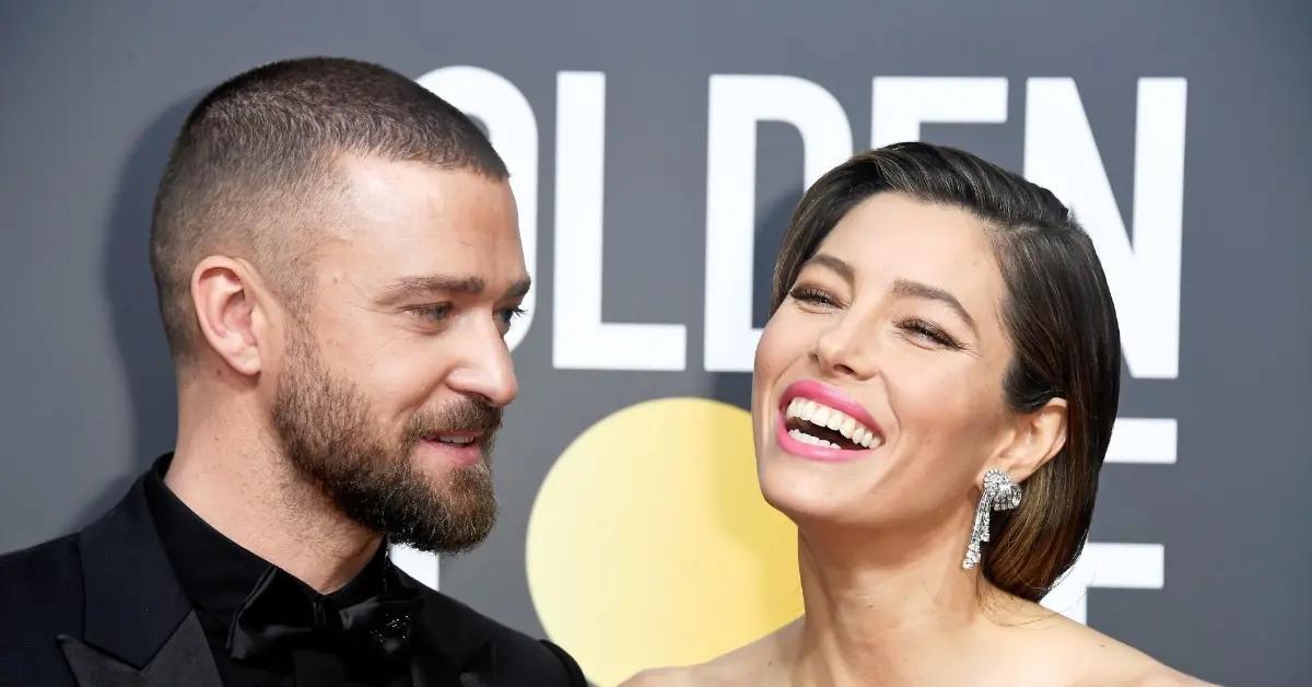 Jessica Biel laughing with Justin Timberlake at an event.