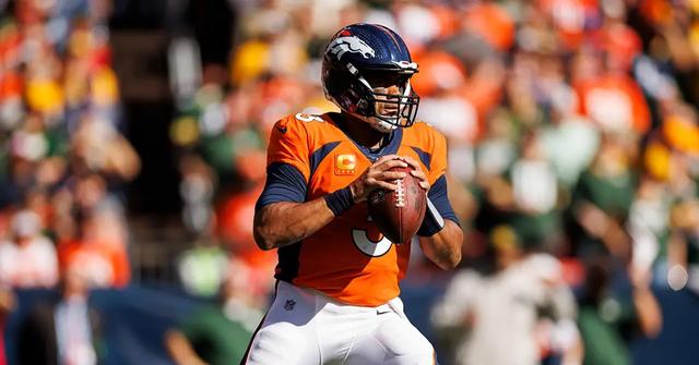 Russell Wilson preparing to throw during a game against the Green Bay Packers.