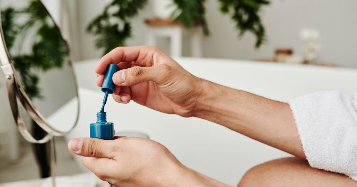 Man holding nail polish