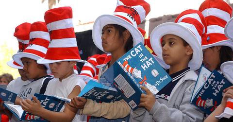 children reading 'cat in the hat' in 'cat in the hat' hats