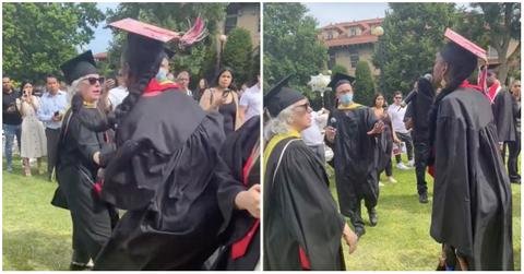 A woman grabs the mic back from a school administrators hand.