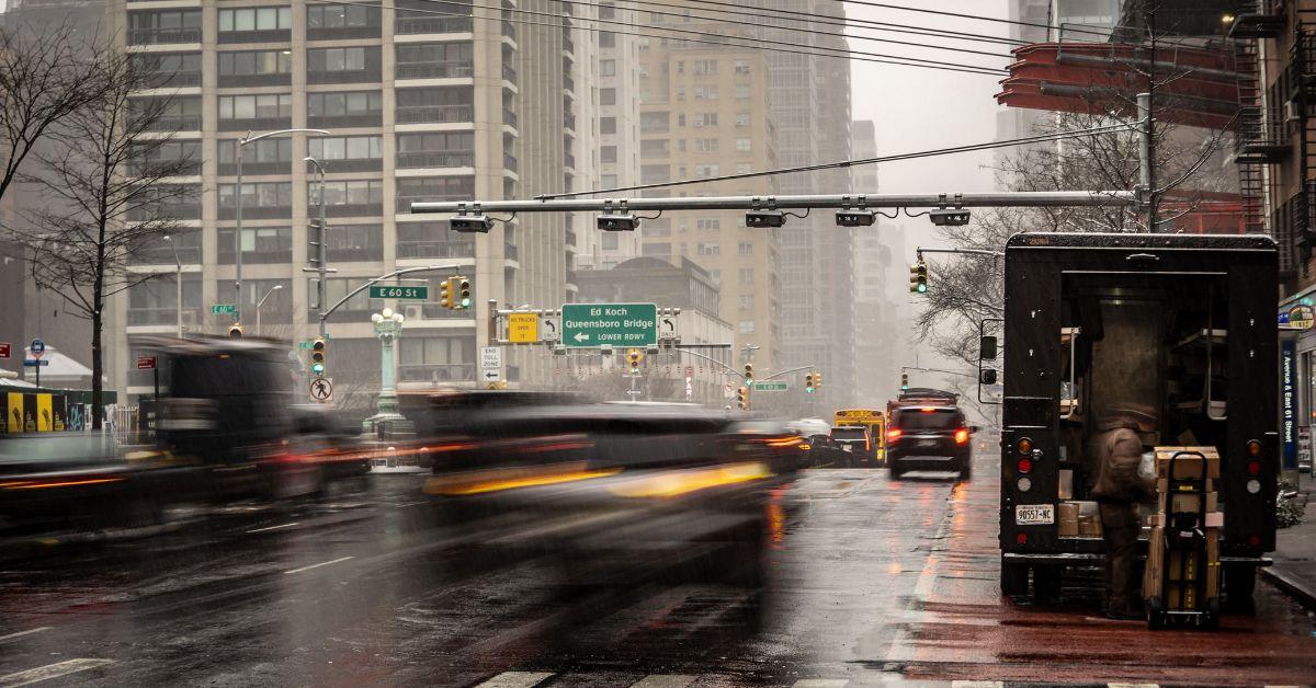 Cars driving by in New York City. 