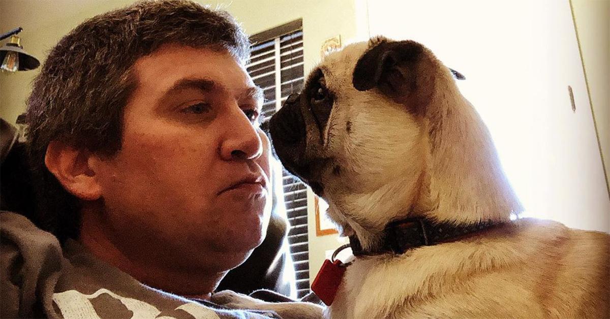 Benji Gregory and his dog Hans cuddling together. 