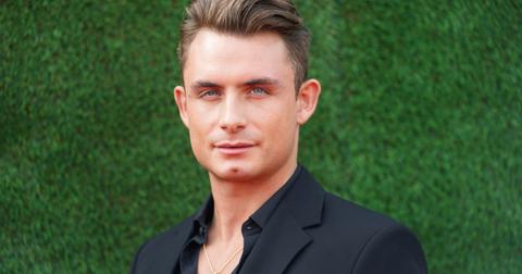 james kennedy in front of a greenery wall