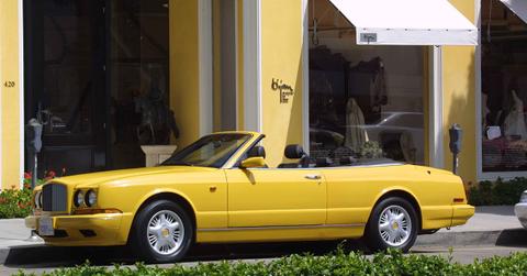 A yellow convertible parked on Rodeo Drive.