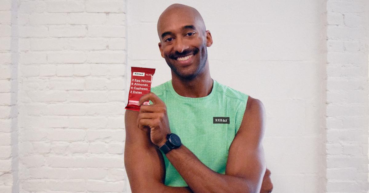 Matt James poses with an RXBAR Strawberry Protein Bar.