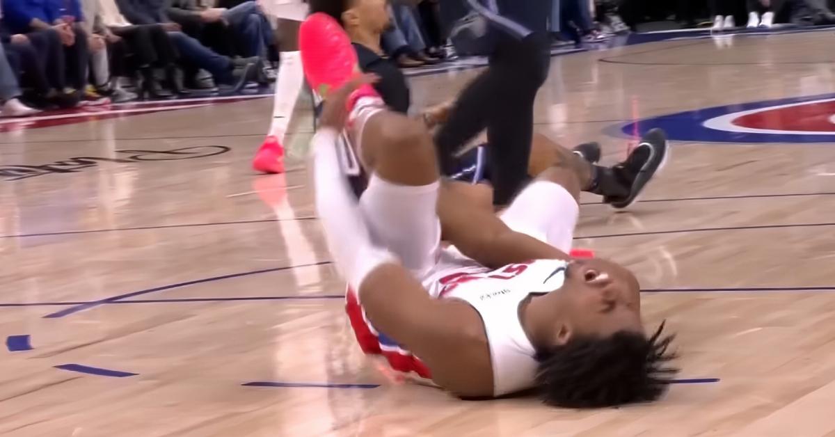 Detroit Pistons guard Jaden Ivey grabs his left leg and screams in pain during the team's game on Jan. 1, 2025.