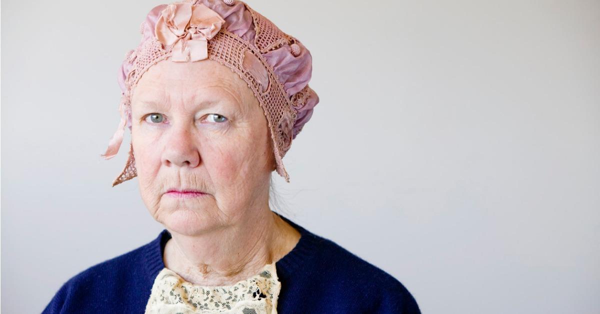 woman in blue wearing a pink vintage hat picture id