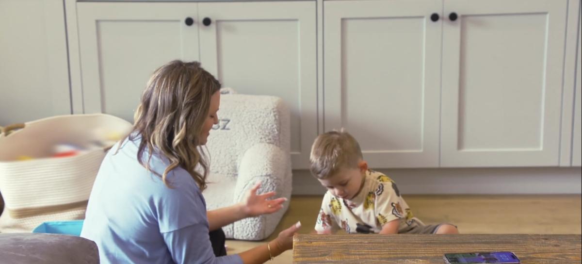 Jax and Brittany's son Cruz sits on the floor with his speech therapist