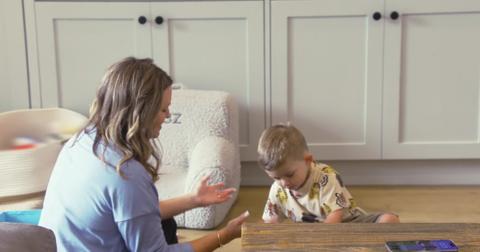 Jax and Brittany's son Cruz sits on the floor with his speech therapist