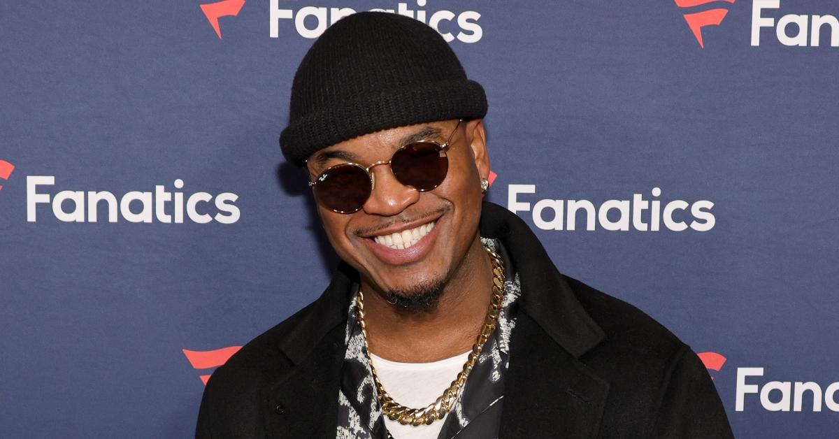 Ne-Yo wearing chain, sunglasses, hat, black jacket at 2024 Super Bowl party
