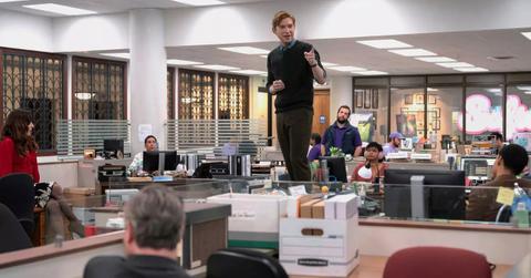 Domhnall Gleeson stands on a desk during the pilot episode of 'The Paper.'