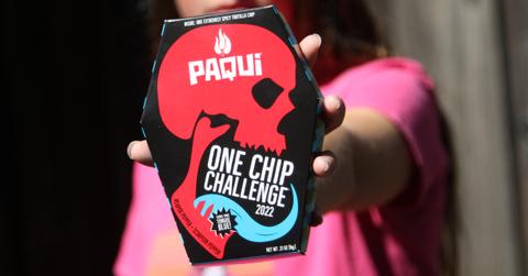 A woman shows off the Paqui "one chip challenge" box.