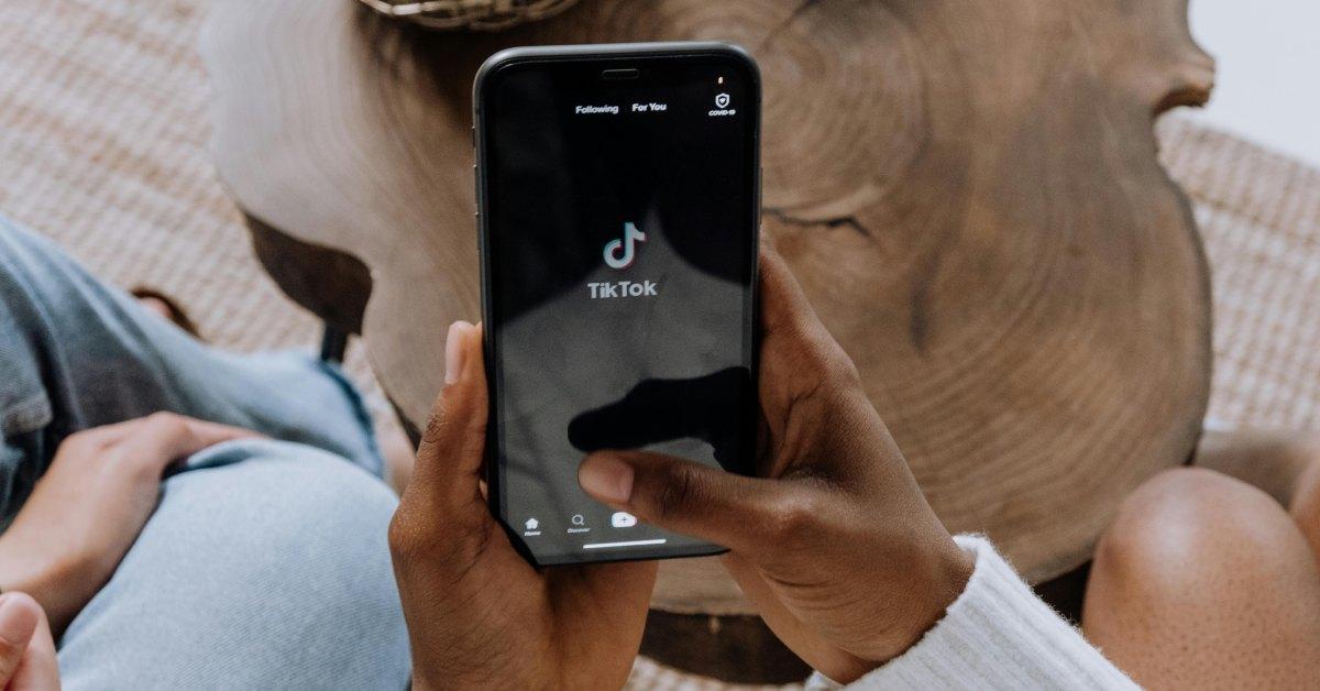 The TikTok app opening on a phone.