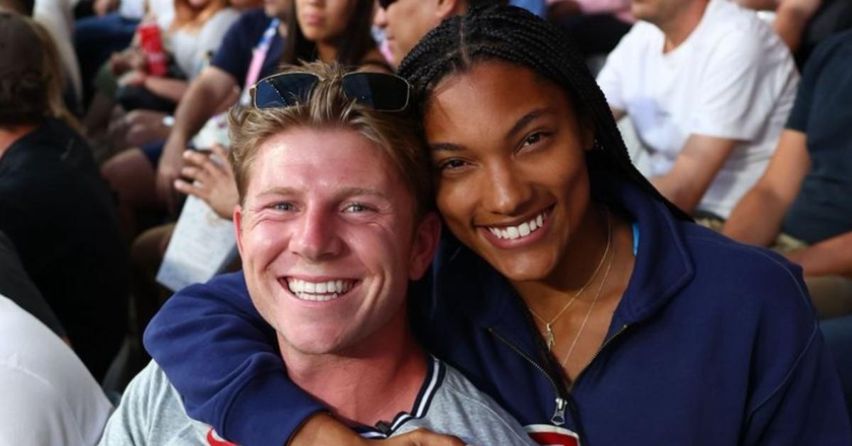 Hunter Woodhall and his wife at a sporting event.