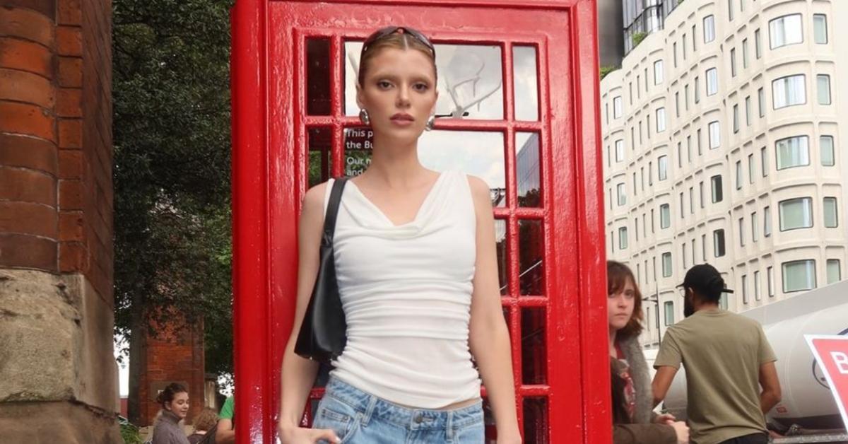 Alissa Violet in white sleeveless top in front of red phone booth in London