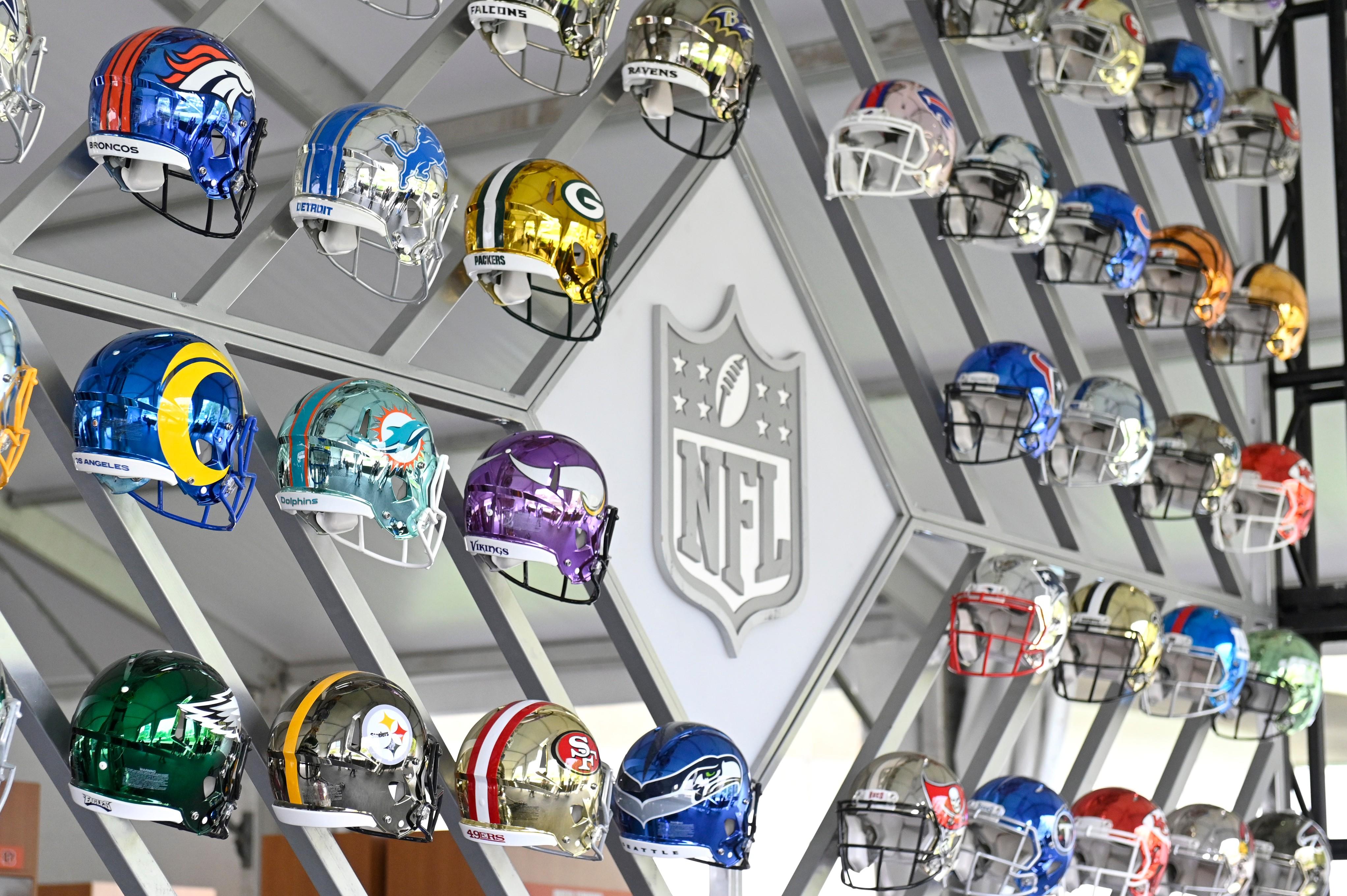 A wall of NFL helmets