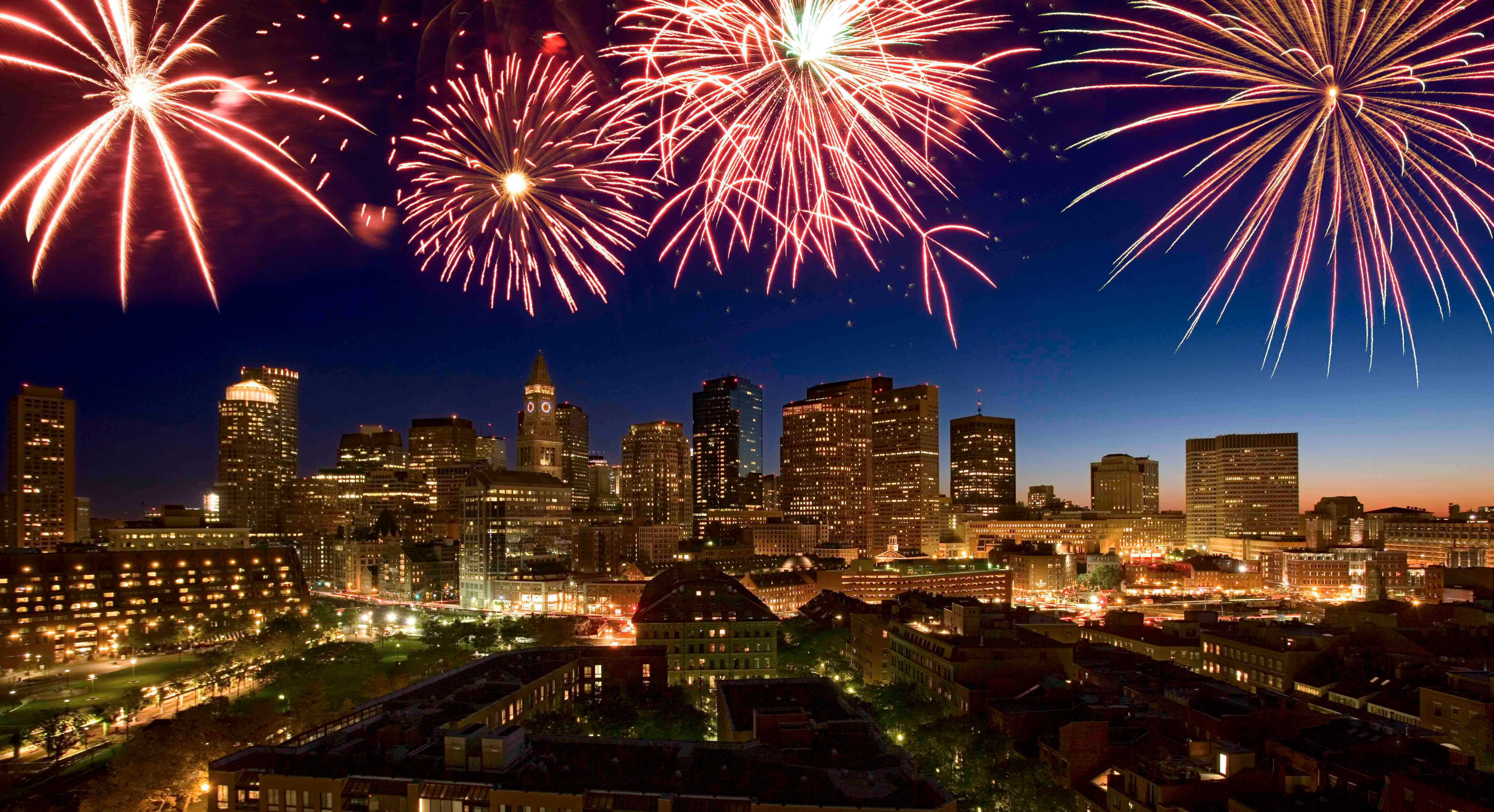 A fireworks display goes off in the Boston skyline.