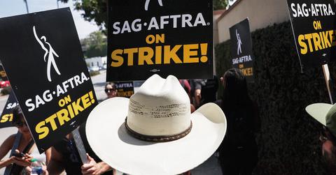 The SAG-AFTRA picket line with a straw hat in the foreground.